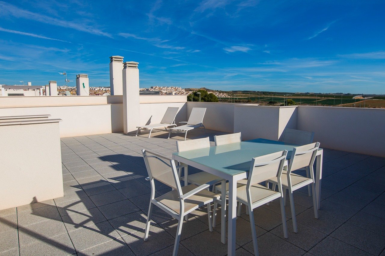 Sun-drenched spacious solarium with modern outdoor furniture atop 2-bedroom top floor apartment in Vistabella Golf, Orihuela.