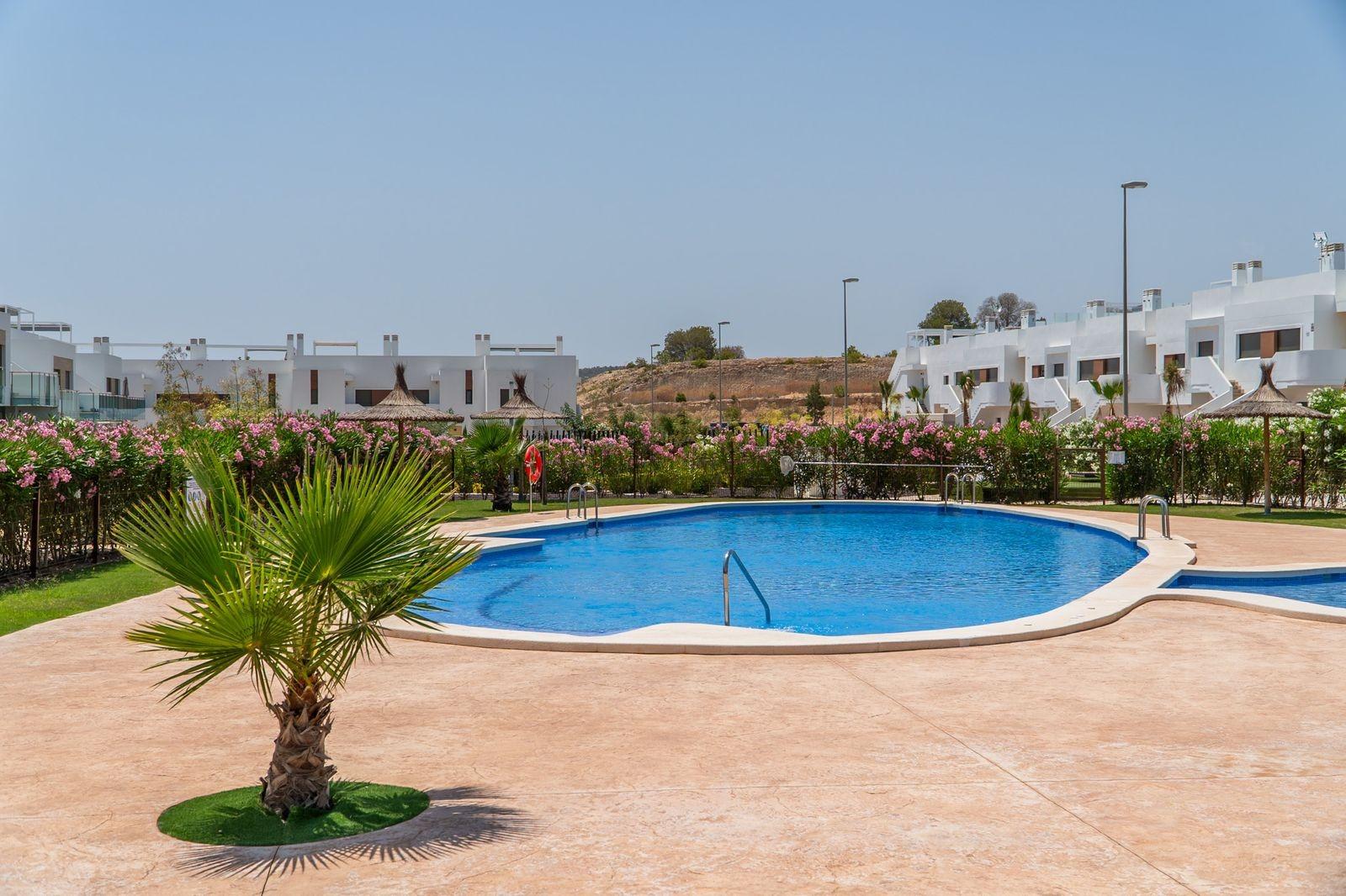 NEW-BUILD-RESIDENTIAL-OF-BUNGALOW-APARTMENTS-IN-VISTABELLA-27 Sun-drenched communal pool with landscaped gardens surrounding modern new build 2-bedroom top floor bungalows in Vistabella Golf, Orihuela.