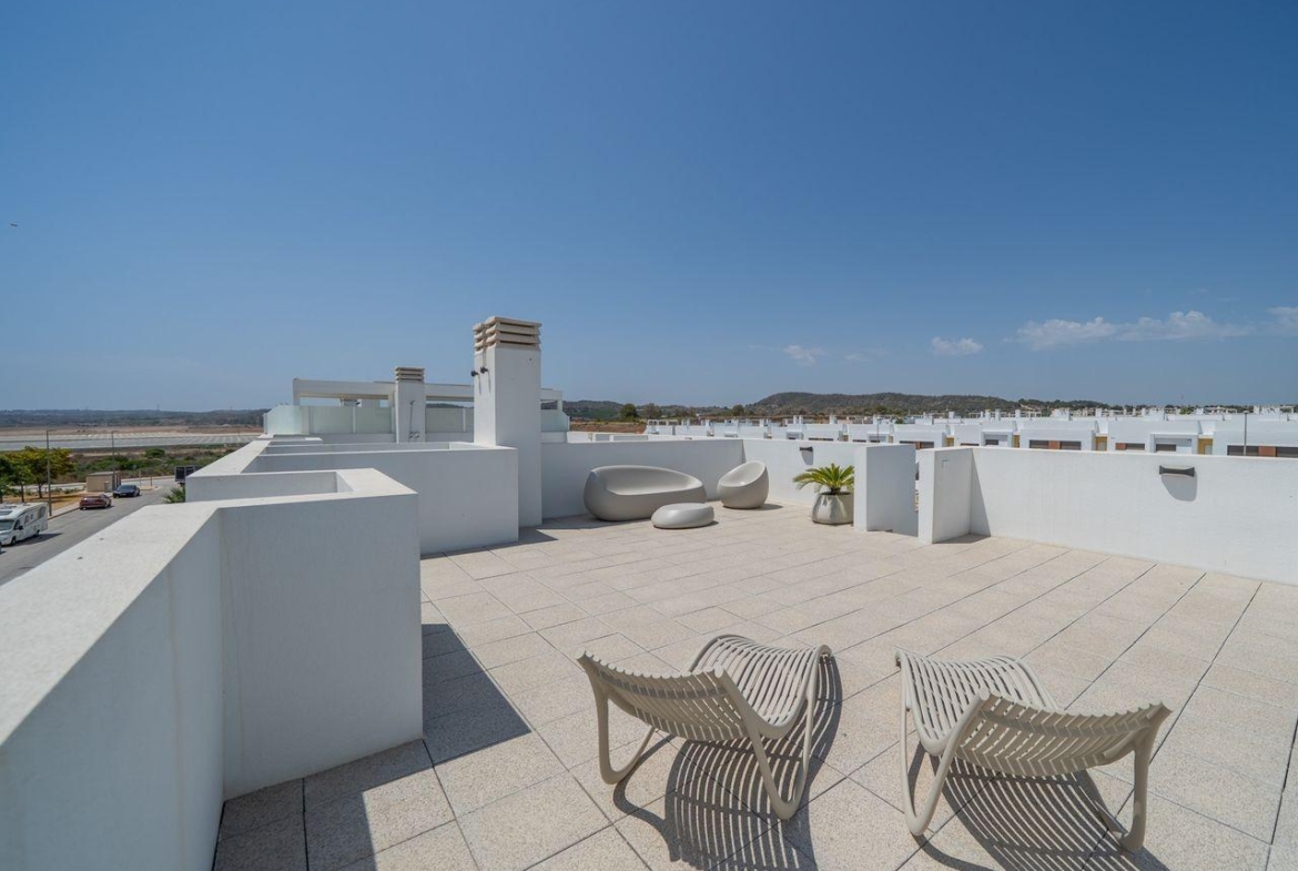 Spacious sun-drenched solarium with modern loungers in a sleek 2 bedroom townhouse at Vistabella Golf, Orihuela.