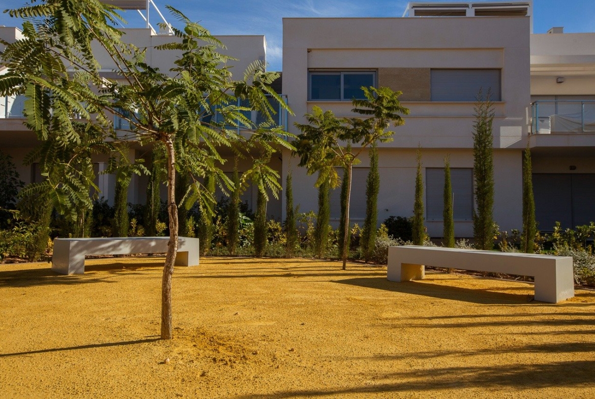Modern key ready 2-bedroom top floor apartment exterior surrounded by landscaped greenery in Vistabella Golf, Orihuela