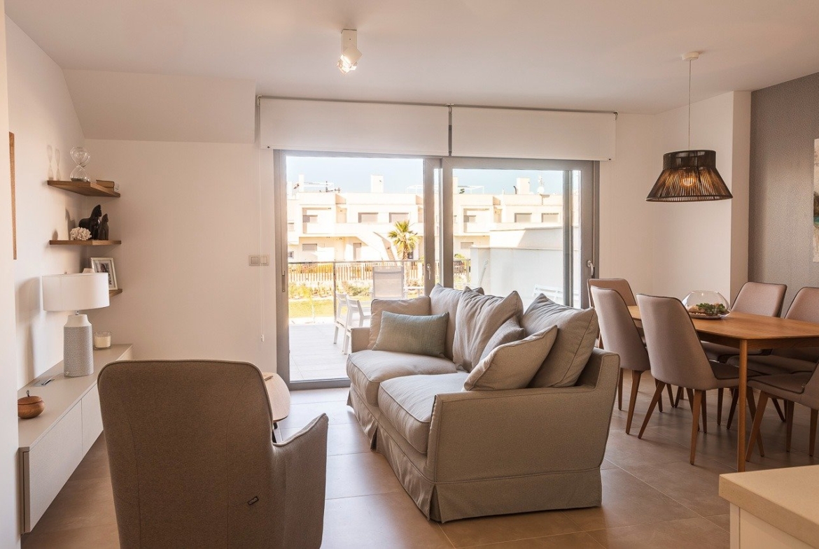 Bright and modern open-plan living and dining area with terrace in key ready 2-bedroom top floor apartment, Vistabella Golf, Orihuela.