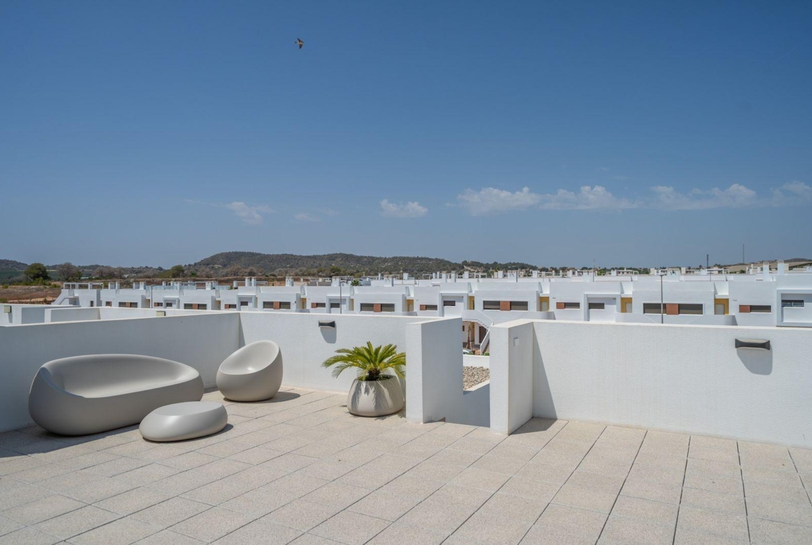 Spacious sun-drenched solarium terrace with modern lounge seating atop a 2 bedroom top floor bungalow in Vistabella Golf, Orihuela.