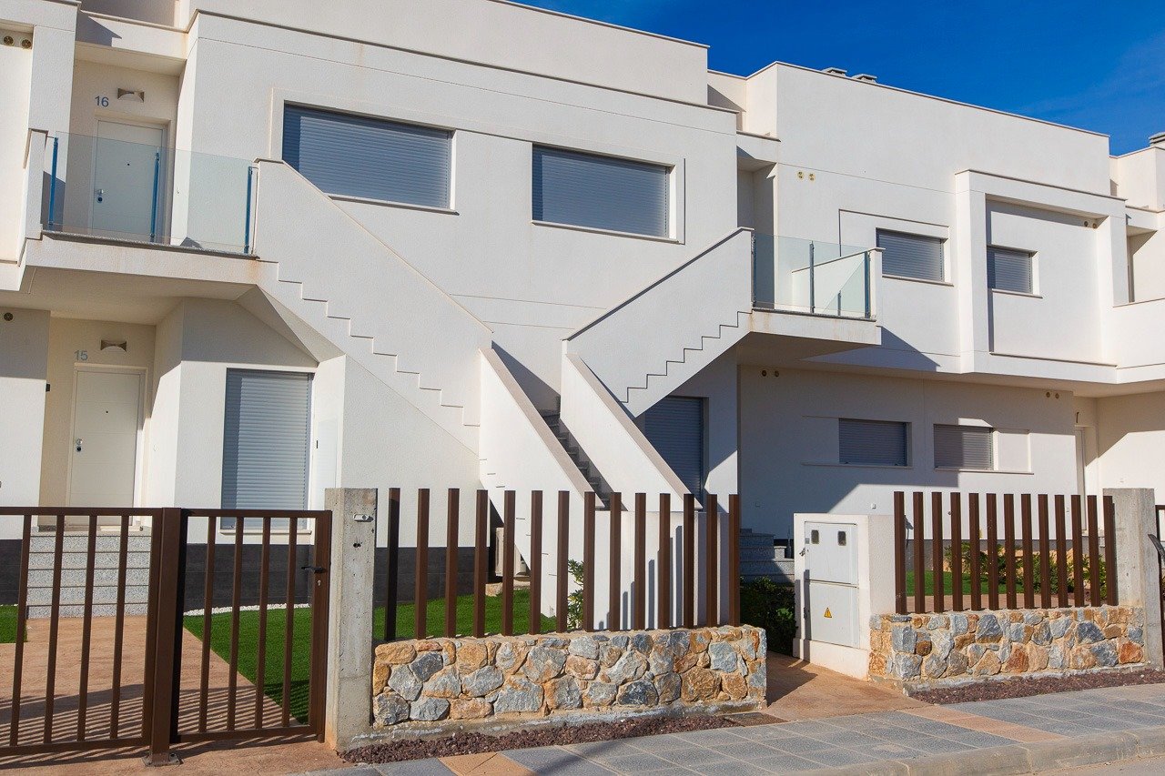 Modern sunlit top floor 2-bedroom apartment exterior with private solarium and landscaped garden in Vistabella Golf, Orihuela.