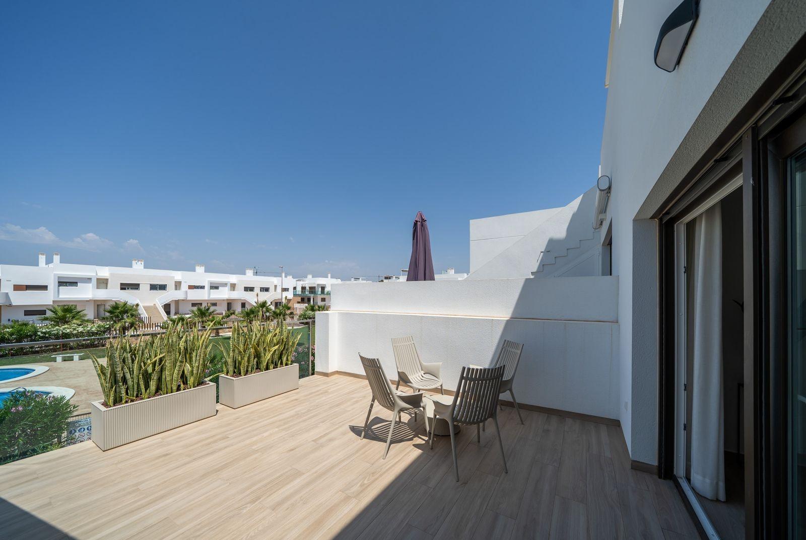 NEW-BUILD-RESIDENTIAL-OF-BUNGALOW-APARTMENTS-IN-VISTABELLA-4 Sun-drenched top floor terrace with modern outdoor seating in a 2-bedroom bungalow at Vistabella Golf, Orihuela.