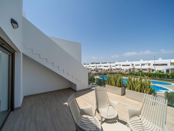 Spacious sun-drenched terrace with modern outdoor seating in 2 bedroom top floor bungalow overlooking pool, Vistabella Golf Orihuela