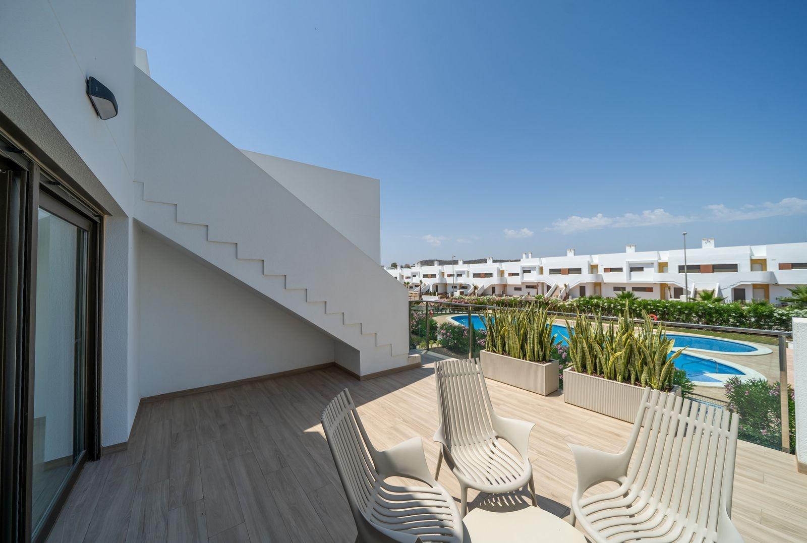 NEW BUILD RESIDENTIAL OF BUNGALOW APARTMENTS IN VISTABELLA Spacious sun-drenched terrace with modern outdoor seating in 2 bedroom top floor bungalow overlooking pool, Vistabella Golf Orihuela