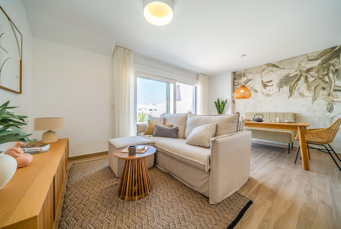 Bright open-plan living area with modern furnishings in 2-bedroom top floor bungalow at Vistabella Golf, Orihuela.