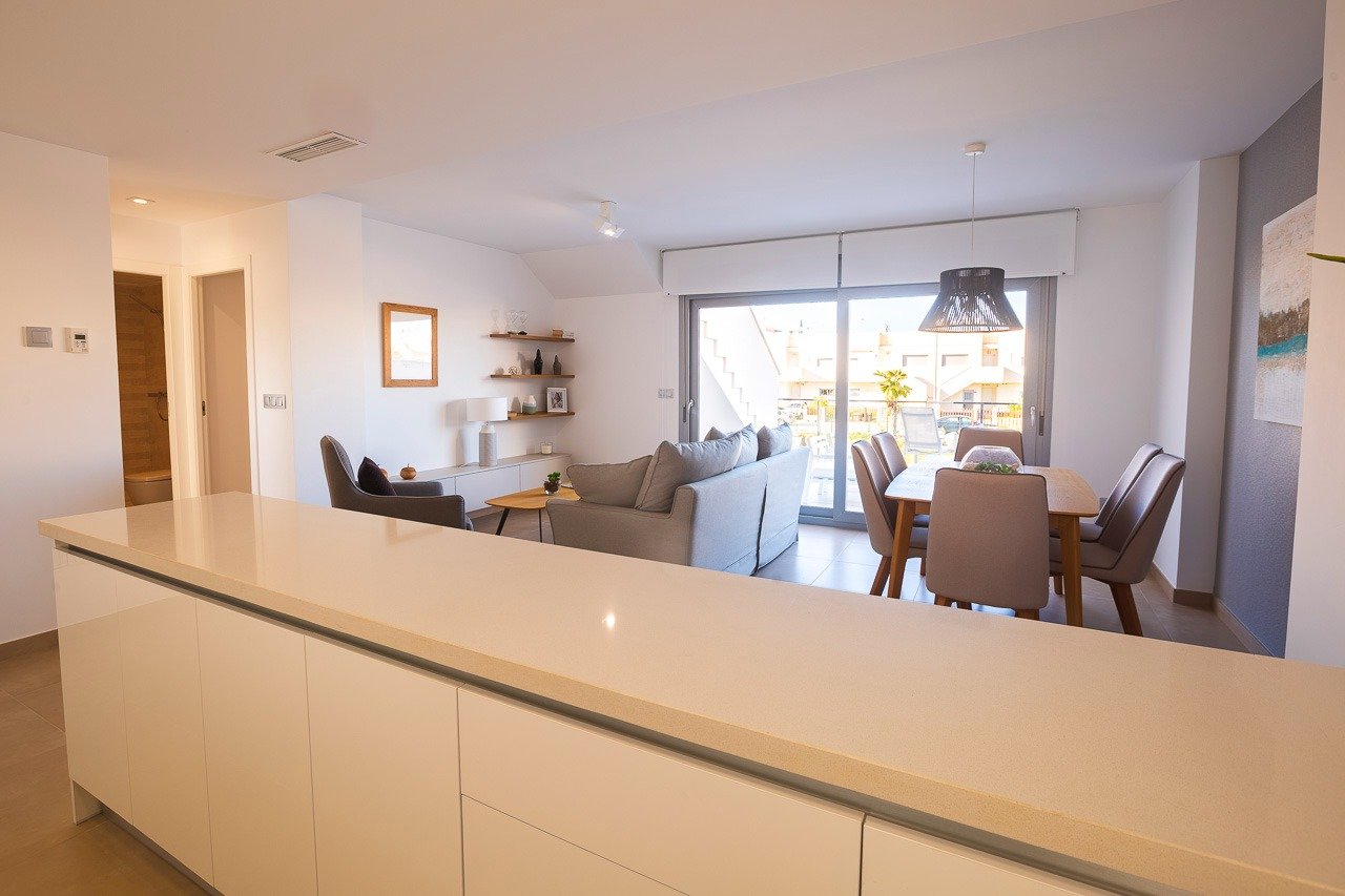 Bright open-plan living and dining area in a modern 2-bedroom top floor apartment with terrace in Vistabella Golf, Orihuela