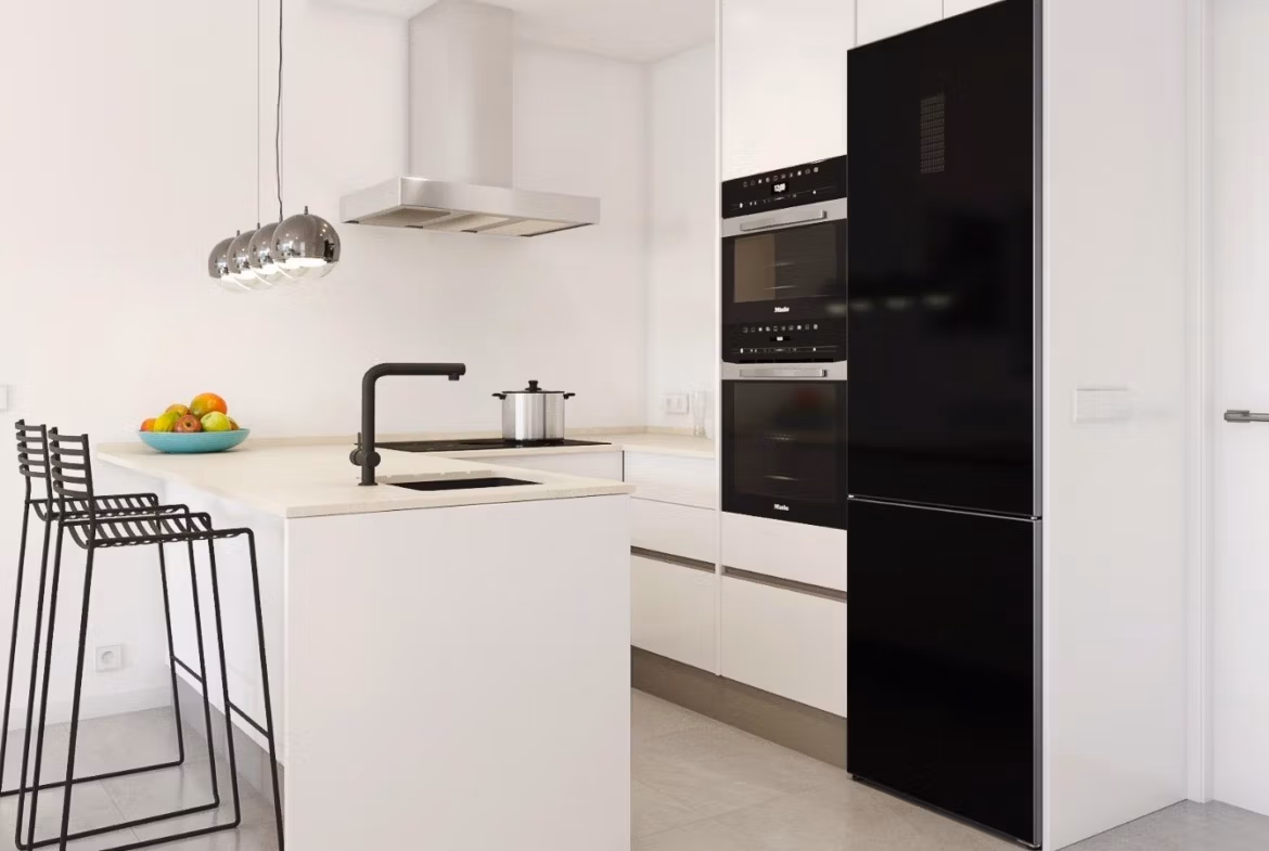Modern bright kitchen with sleek black appliances and minimalist island in a new build 3-bedroom villa in Pilar de la Horadada.