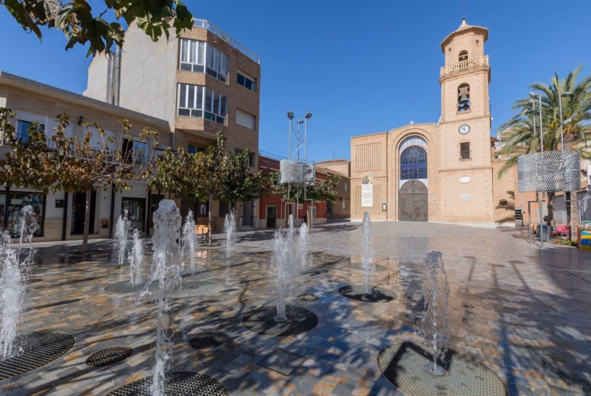 Sunlit historic square with decorative fountains and charming architecture near the new build villa in Pilar de la Horadada.