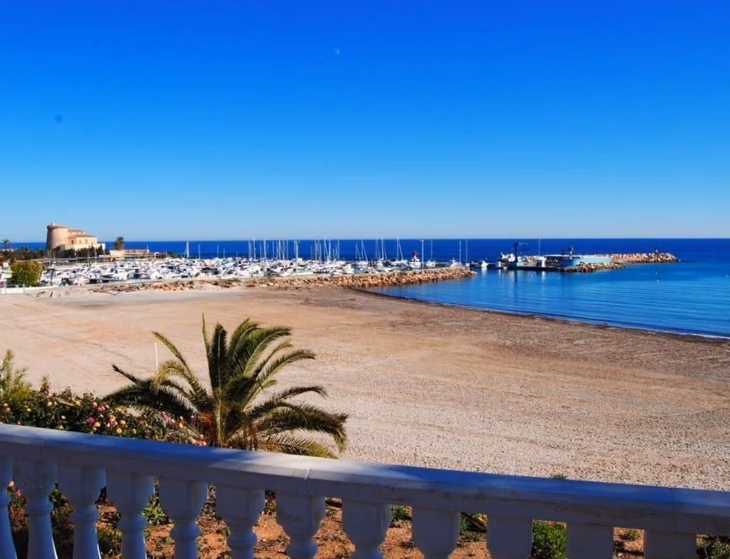 Panoramic sun-drenched beach and marina view from the elegant corner villa terrace in Pilar de la Horadada.