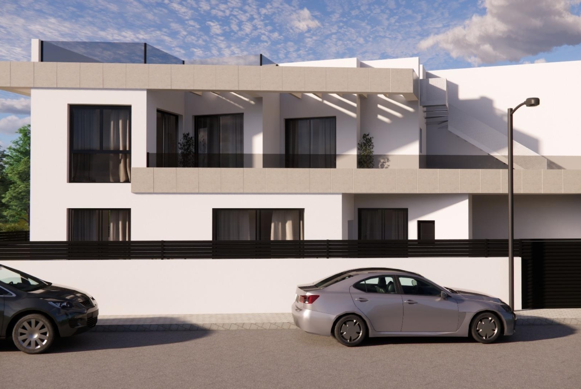 Sleek modern 3-bedroom townhouse in Rojales with bright facade, spacious terraces, and secure gated entrance visible from street view.