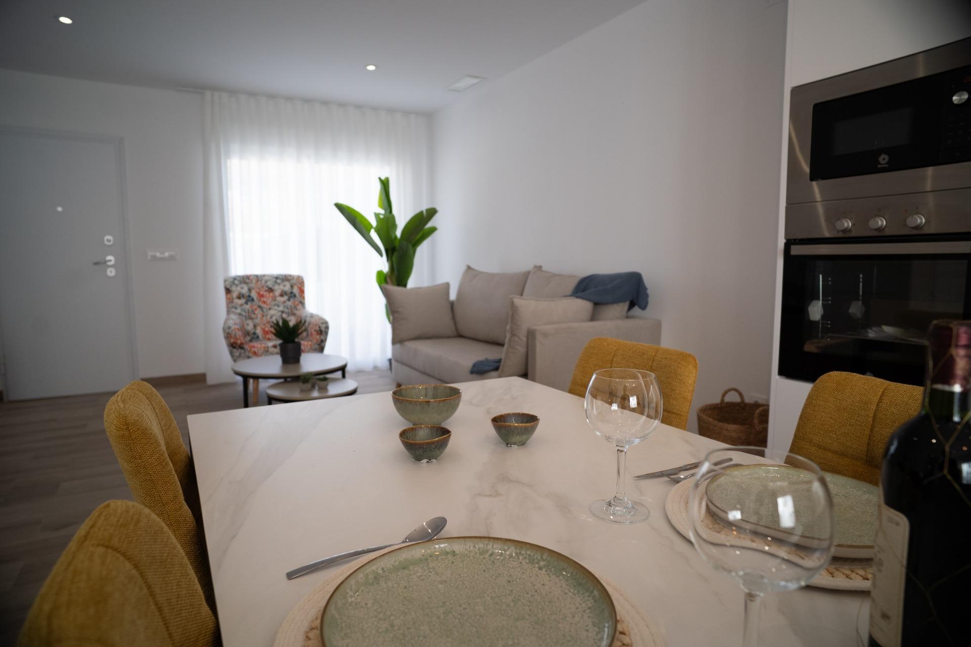 NEW-BUILD-TOWNHOUSES-IN-SAN-JAVIER-12 Bright modern open-plan dining and living area with elegant furnishings in new build townhouses in San Javier