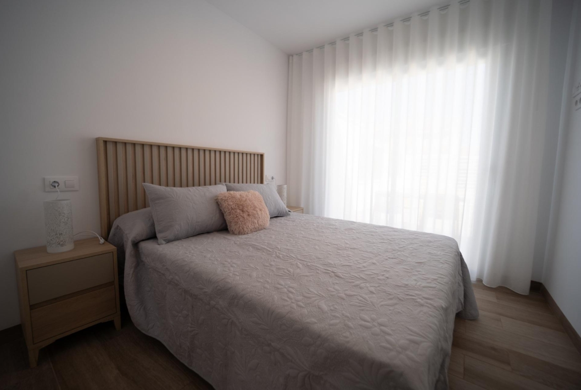 NEW-BUILD-TOWNHOUSES-IN-SAN-JAVIER-13 Bright and serene bedroom with soft textiles and wooden accents in new build townhouses in San Javier