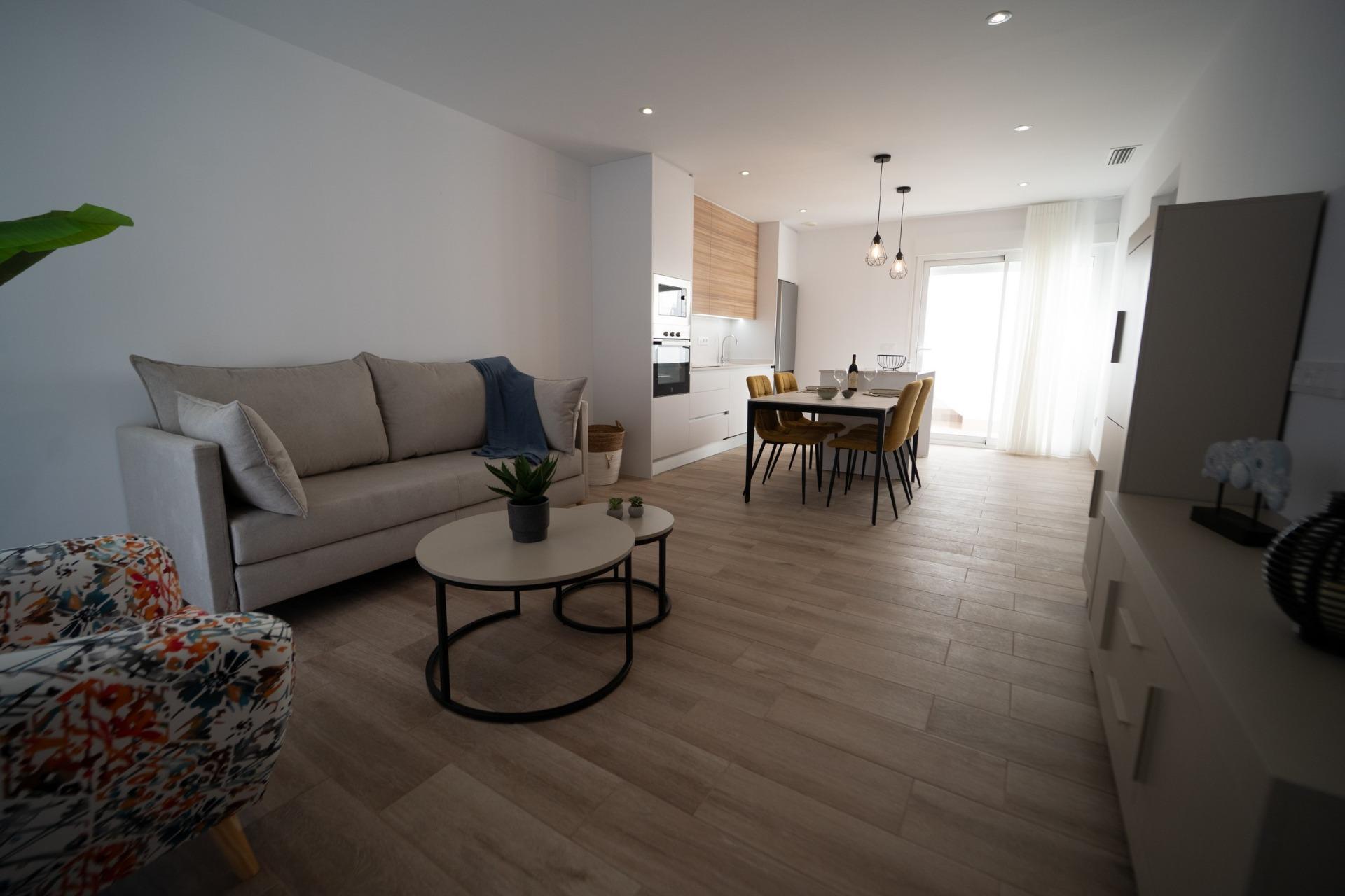 NEW-BUILD-TOWNHOUSES-IN-SAN-JAVIER-13 Bright open-plan living and dining area with modern kitchen in new build townhouses in San Javier.