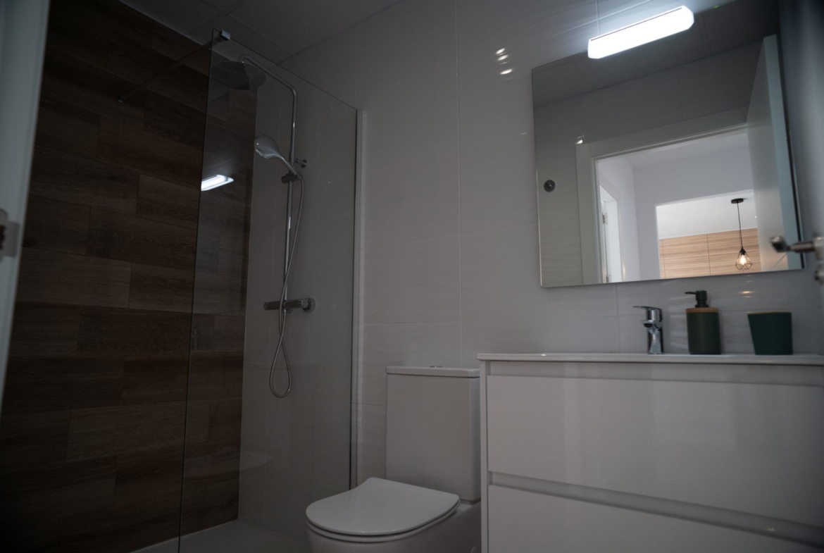 NEW-BUILD-TOWNHOUSES-IN-SAN-JAVIER-19 Modern bathroom with sleek walk-in shower and minimalist fixtures in new build townhouses in San Javier