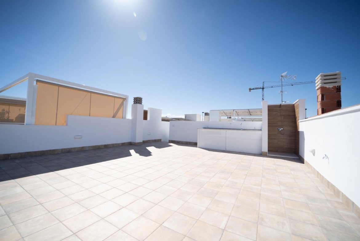 Spacious sun-drenched tiled terrace with outdoor shower and modern amenities in new build townhouses in San Javier