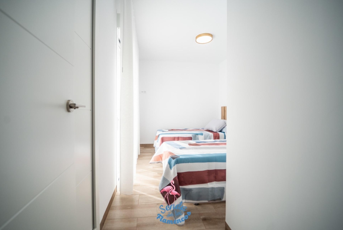 Bright minimal twin bedroom with modern decor and natural light in new build townhouses in San Javier