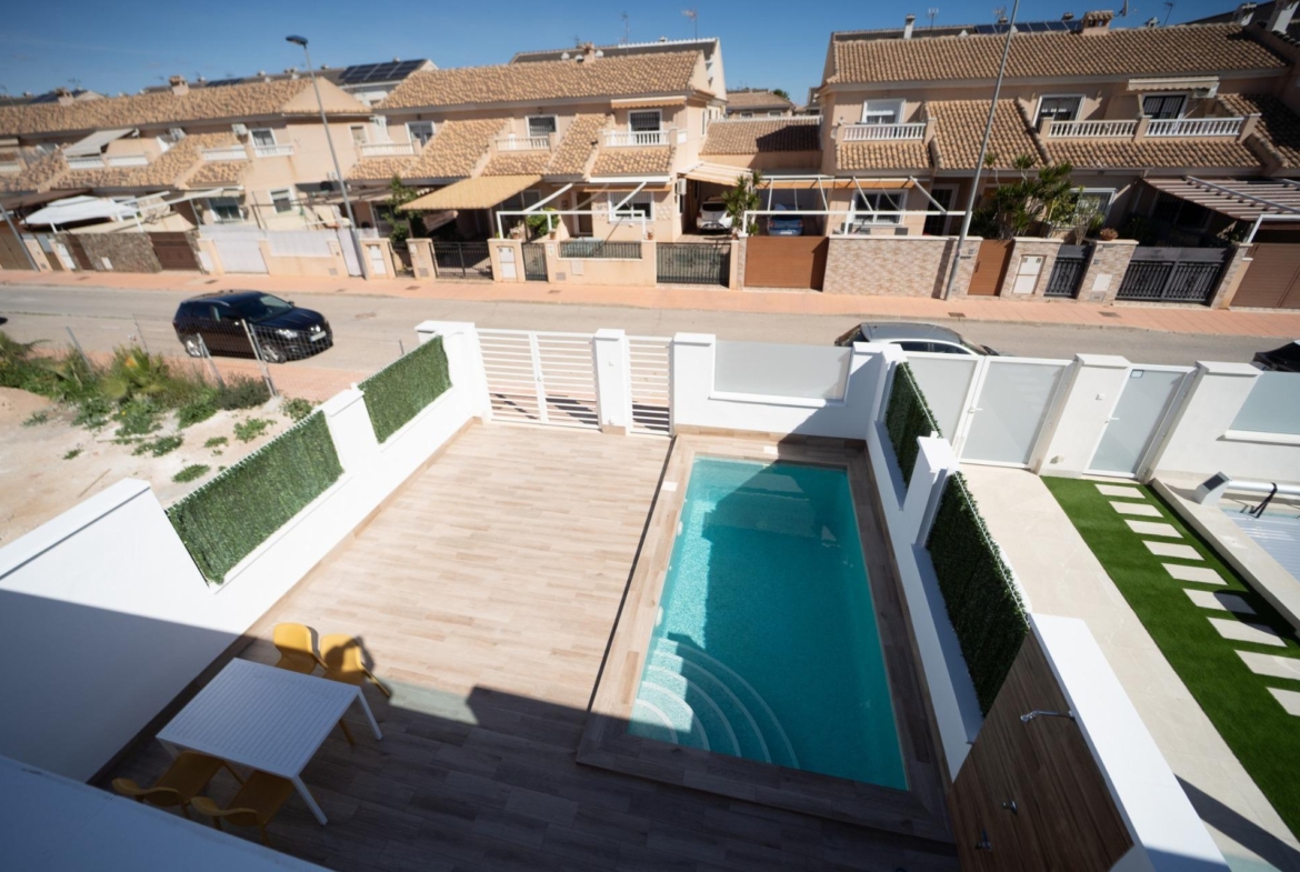 Modern sun-drenched townhouse in San Javier with private sparkling pool, spacious terrace, and sleek outdoor dining area.