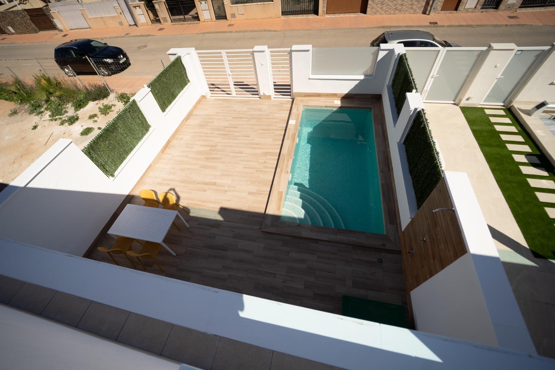 NEW-BUILD-TOWNHOUSES-IN-SAN-JAVIER-4 Private sun-drenched terrace with intimate pool and modern outdoor dining area in new build townhouses in San Javier