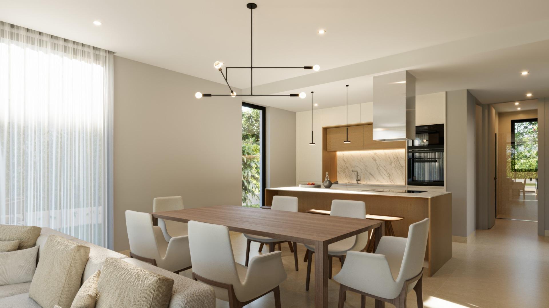 Bright modern open-plan dining and kitchen area in exclusive 3-bedroom villa at Sierra Cortina, Finestrat with elegant finishes.