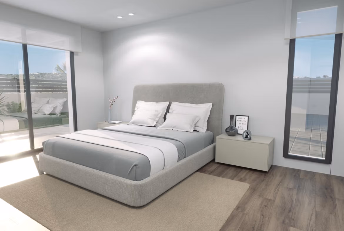 Bright, modern bedroom with minimalist décor and large windows overlooking the sunlit terrace of a new build 3-bedroom villa in Finestrat.