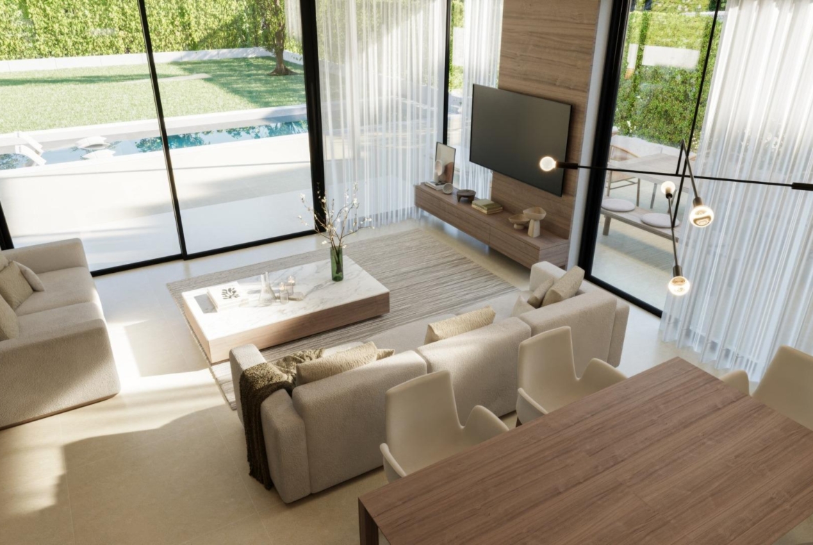 Bright, modern living and dining area in a luxury 3-bedroom villa with floor-to-ceiling windows overlooking the private pool in Sierra Cortina, Finestrat.