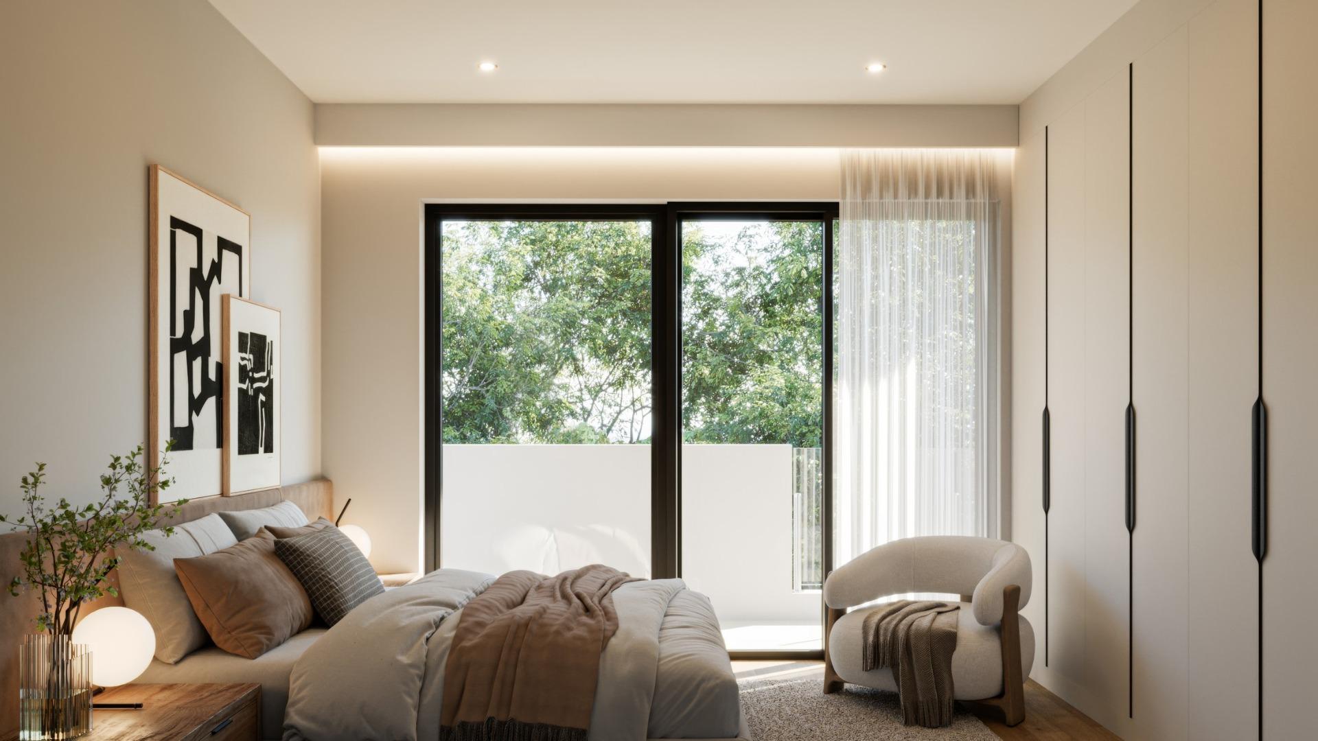 Bright and elegant bedroom in a new 3-bedroom villa in Sierra Cortina, Finestrat with minimalist design and serene garden views