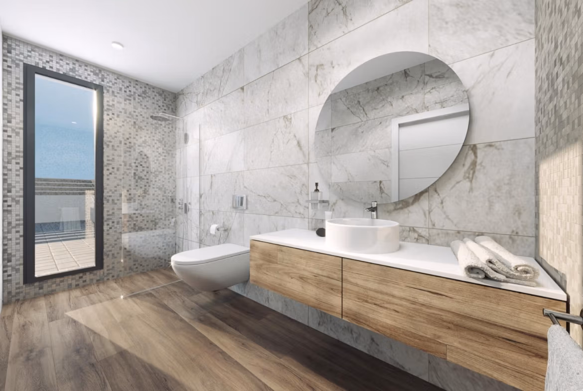 Bright modern bathroom with elegant marble walls and wooden vanity in new build 3 bedroom villa in Finestrat