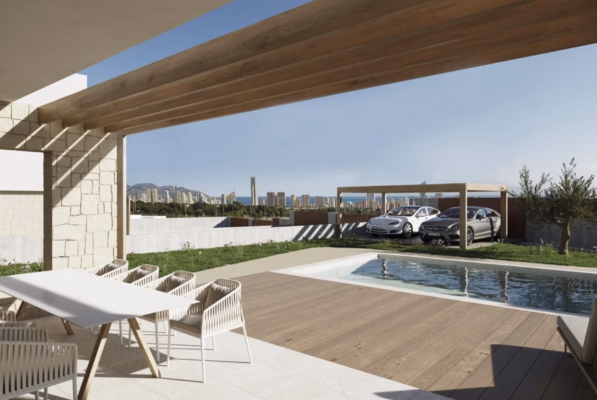 NEW-BUILD-VILLAS-IN-FINESTRAT-2 Modern covered terrace with elegant dining area overlooking private pool and Benidorm skyline at luxury villa in Finestrat.