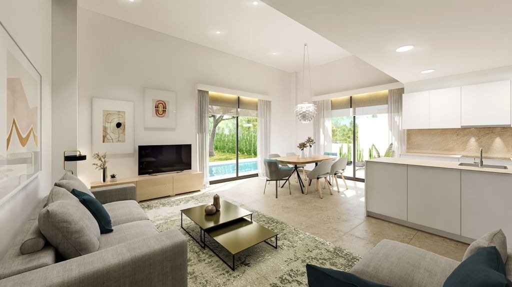Bright open-plan living and dining area with modern kitchen, elegant décor, and pool views in 3-bedroom villa at Sierra Cortina, Finestrat
