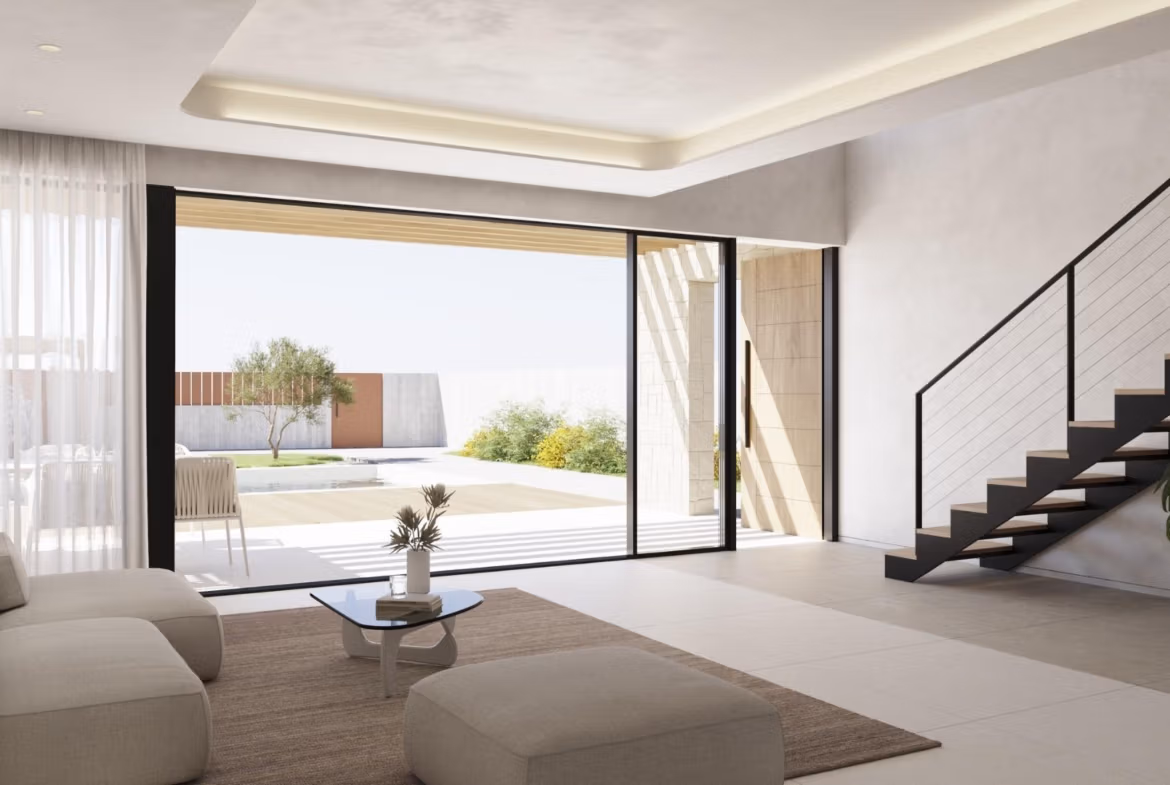NEW-BUILD-VILLAS-IN-FINESTRAT-3 Bright contemporary living room with sleek staircase and panoramic sliding doors opening to a private pool in Finestrat villa.