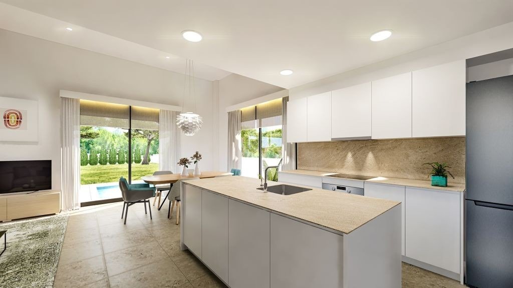 Modern bright kitchen with sleek island and garden views in a 3-bedroom villa in Sierra Cortina, Finestrat