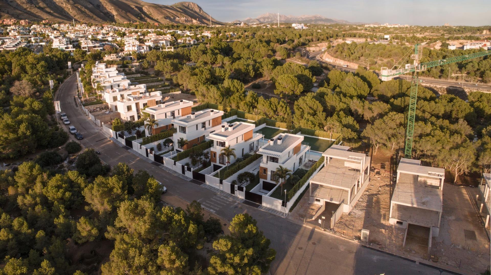 Row of modern luxury 3-bedroom villas with private pools and panoramic sea views in sunlit Sierra Cortina, Finestrat.