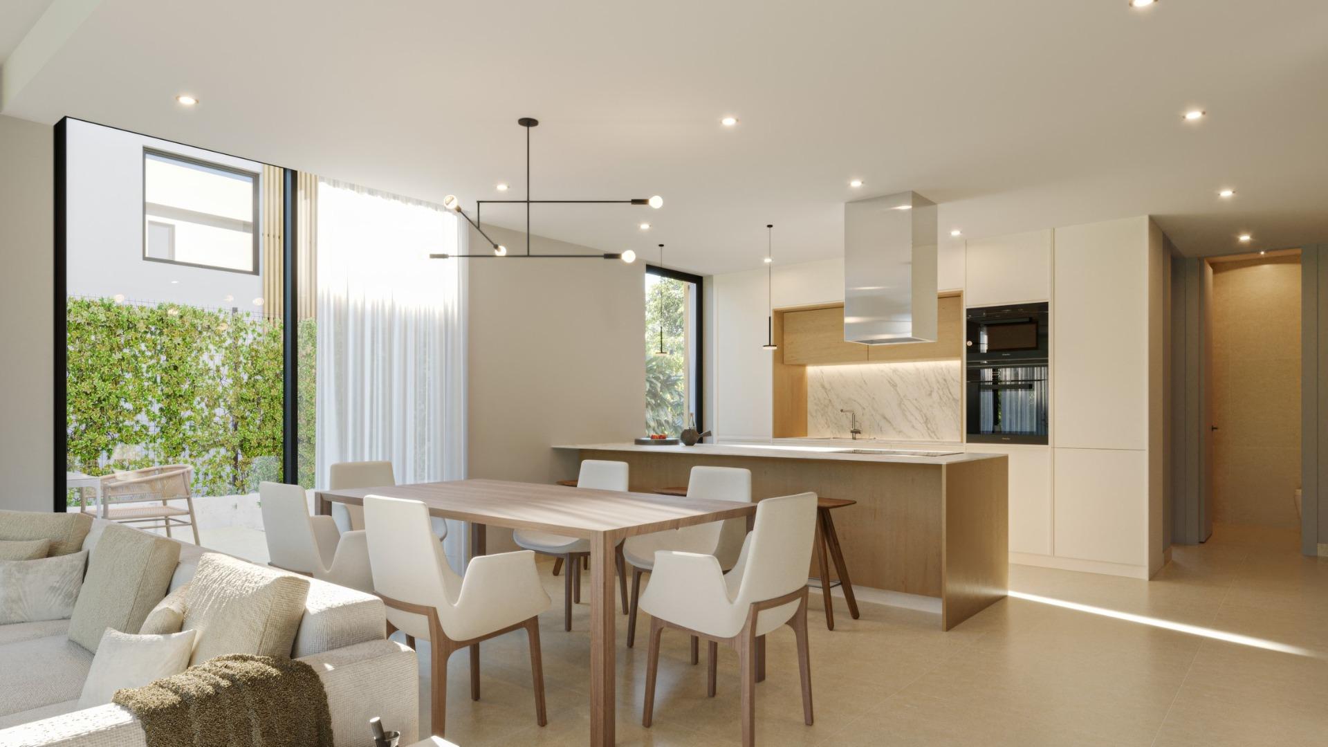 Bright open-plan dining and kitchen area with modern design and natural light in a 3-bedroom villa, Sierra Cortina, Finestrat.