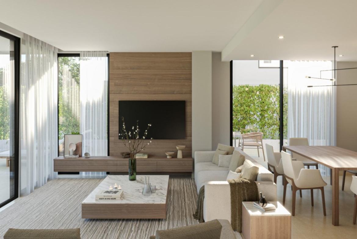 Bright and elegant open-plan living and dining area of new 3-bedroom villa in Sierra Cortina with poolside views.