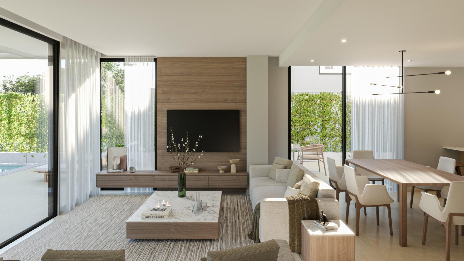Bright and elegant open-plan living and dining area of new 3-bedroom villa in Sierra Cortina with poolside views.