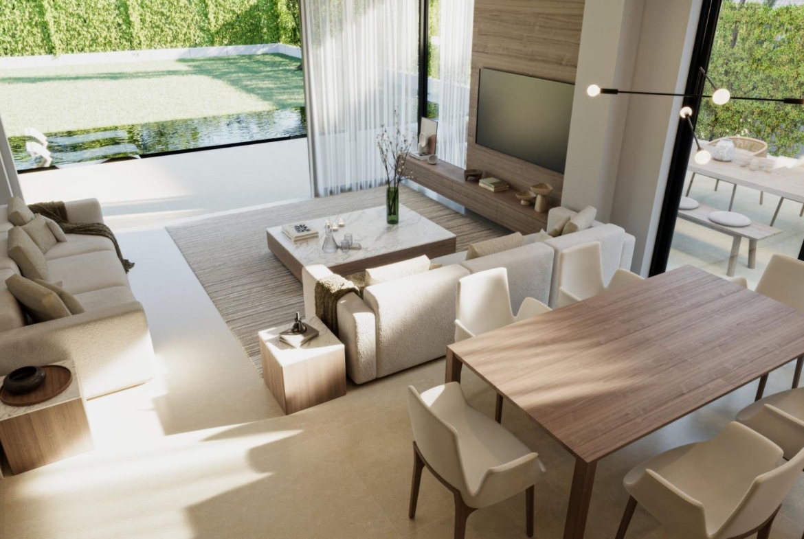 Sunlit open-plan living and dining area with modern furnishings in a luxury 3-bedroom villa in Sierra Cortina, Finestrat.