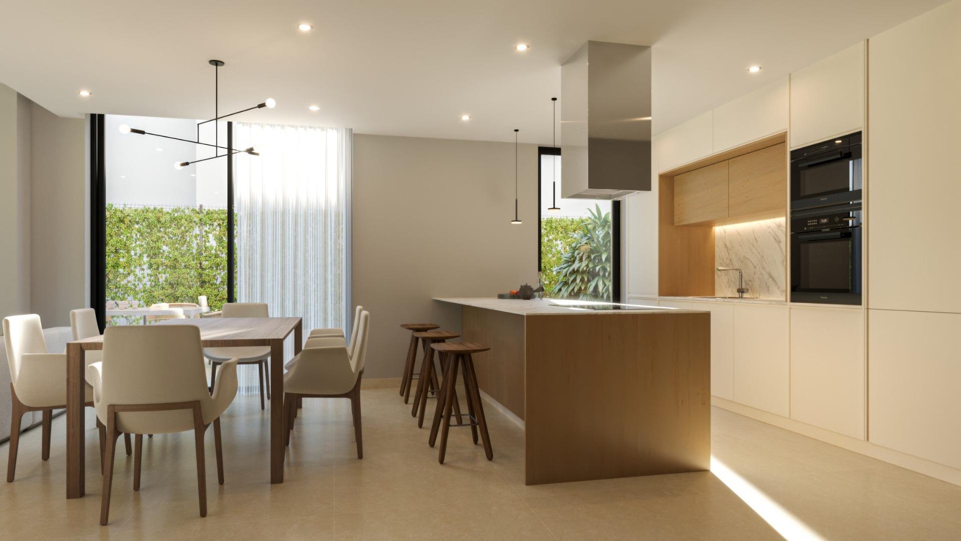 Bright modern kitchen and dining area with sleek wood accents in exclusive 3 bedroom villa, Sierra Cortina, Finestrat
