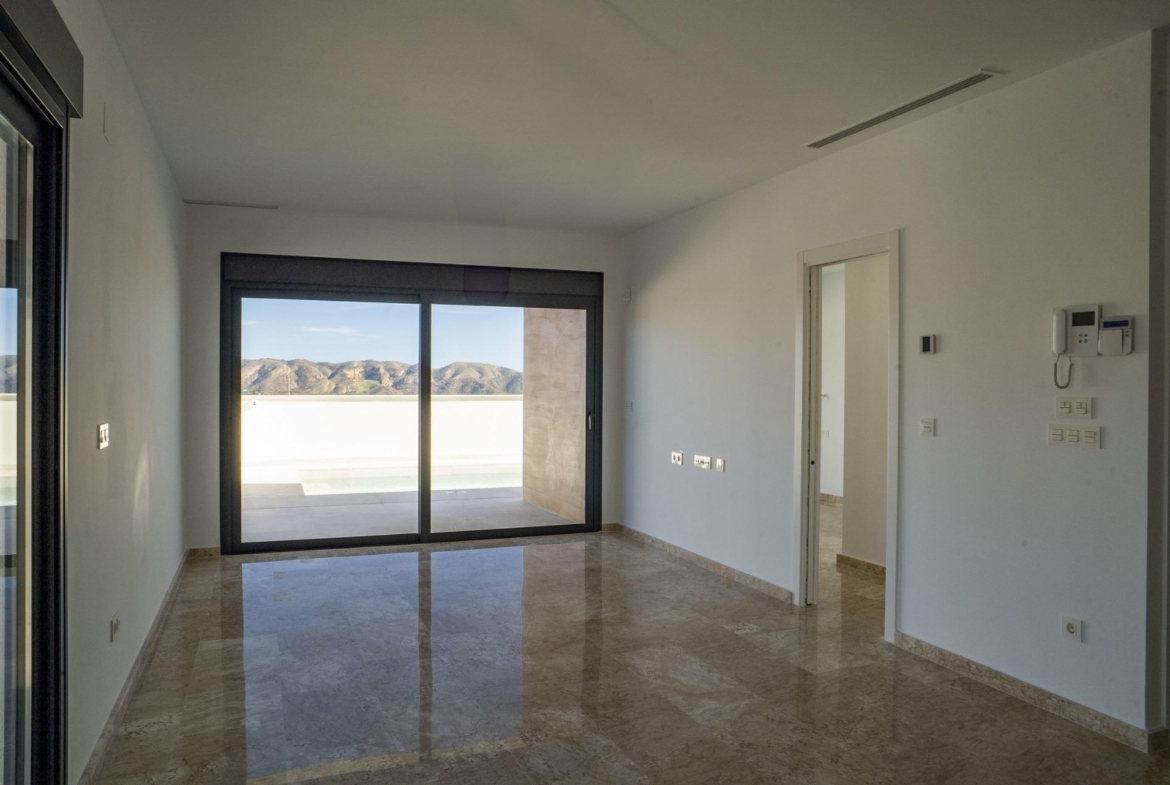 Bright modern living area with glossy floors, floor-to-ceiling windows, and stunning mountain views in La Nucia villa.