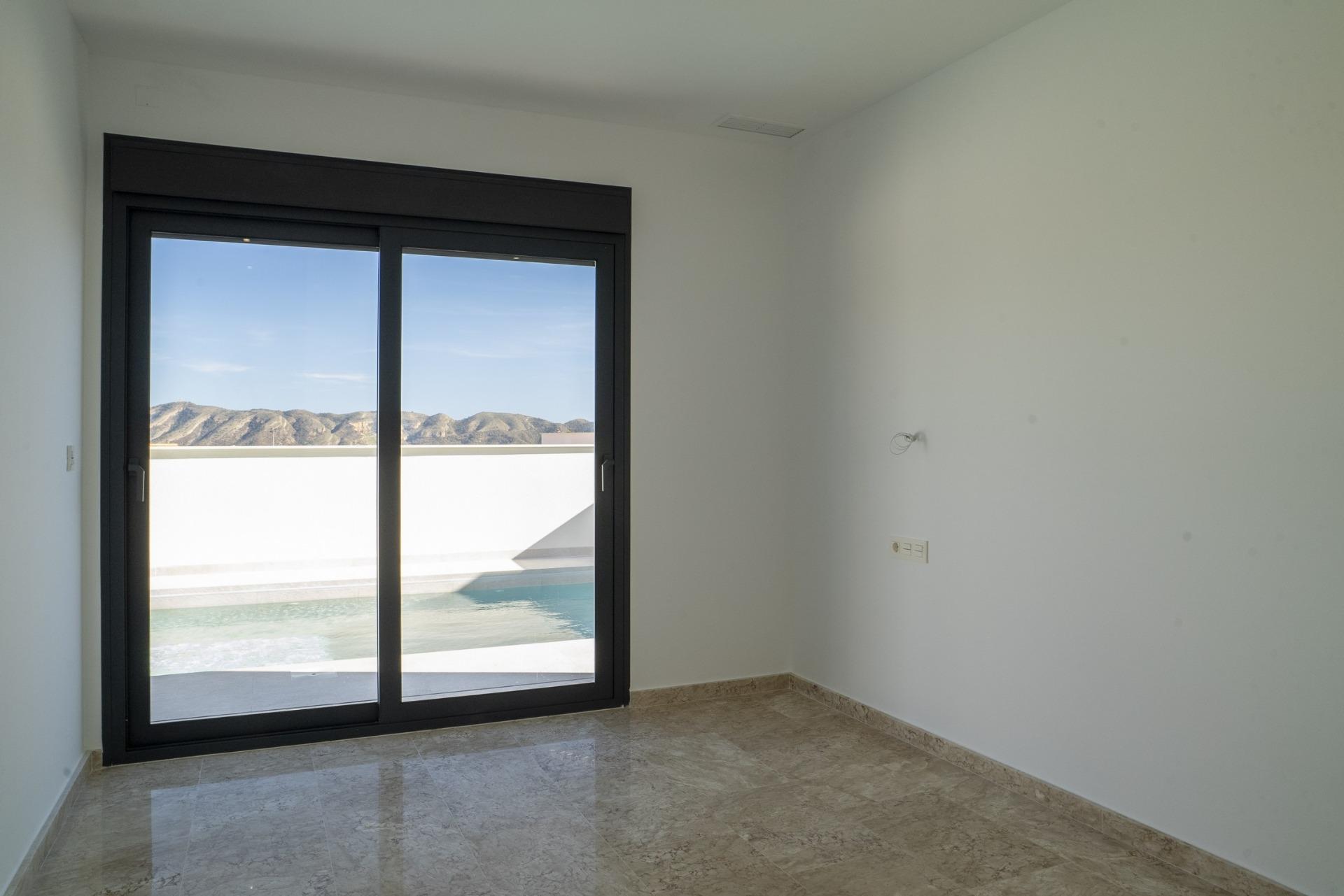 Bright modern bedroom with polished floors and panoramic mountain views in 3-bedroom villa for sale in La Nucia, Costa Blanca