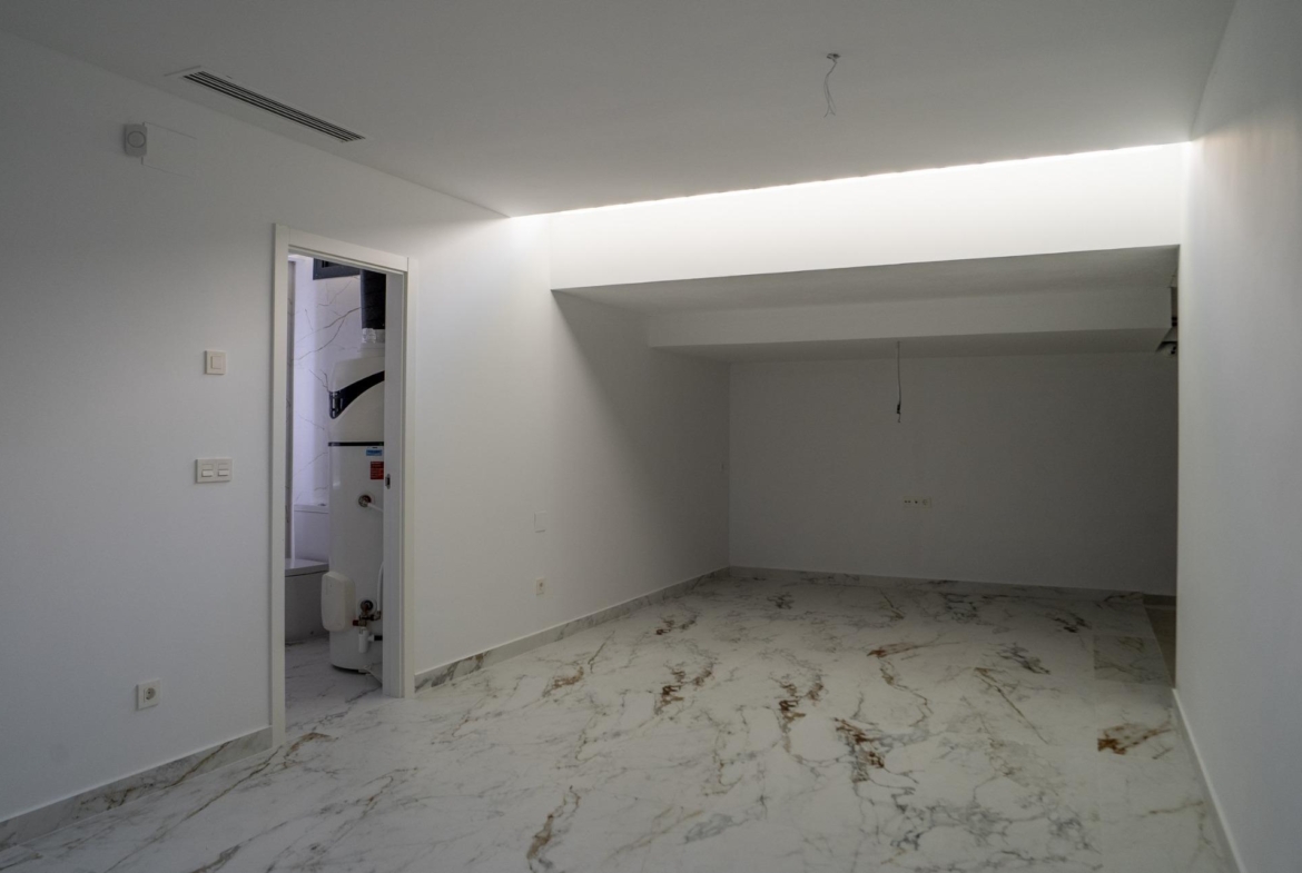 Bright modern interior space with marble flooring in a sleek 3-bedroom villa in La Nucia, Costa Blanca.