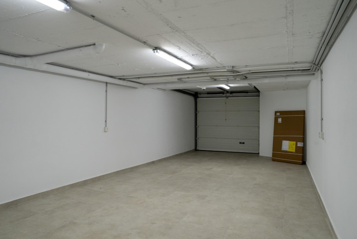 Spacious modern garage with clean tiled floors and bright lighting in luxury 3-bedroom villa, La Nucia, Costa Blanca.