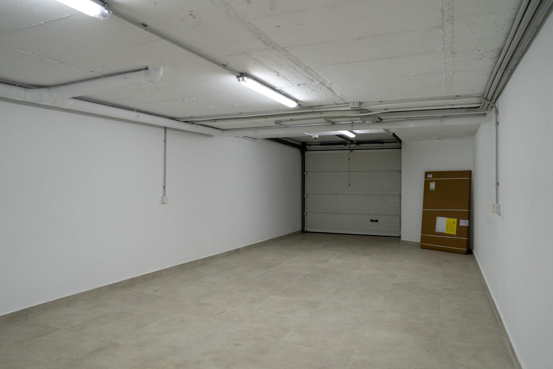 Spacious modern garage with clean tiled floors and bright lighting in luxury 3-bedroom villa, La Nucia, Costa Blanca.