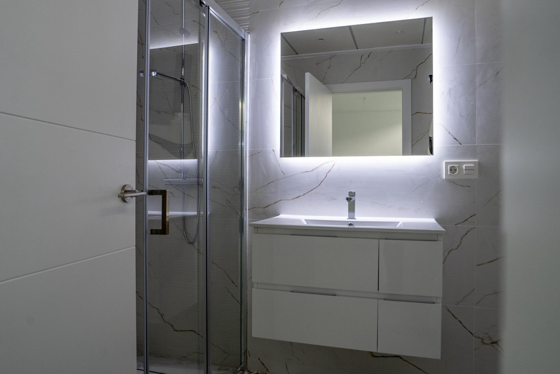 Elegant modern bathroom with illuminated mirror and sleek shower in a 3-bedroom villa in La Nucia, Costa Blanca.