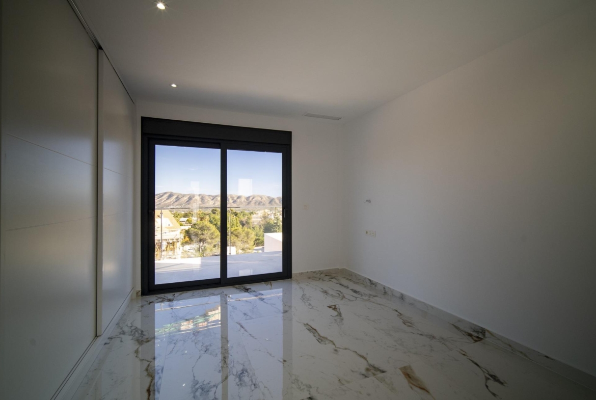 Bright modern bedroom with marble flooring and large window in new build 3 bedroom villa in La Nucia, Costa Blanca