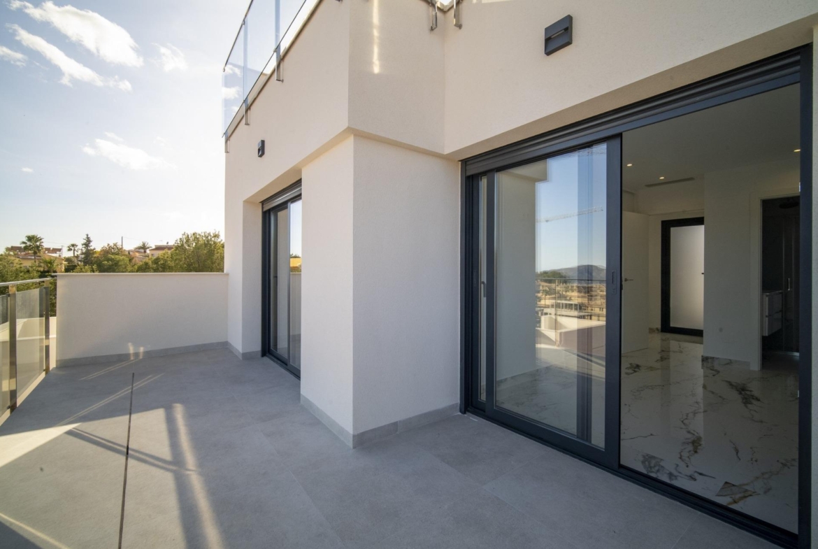 Spacious sun-drenched terrace with sleek glass doors in modern 3-bedroom villa for sale in La Nucia, Costa Blanca