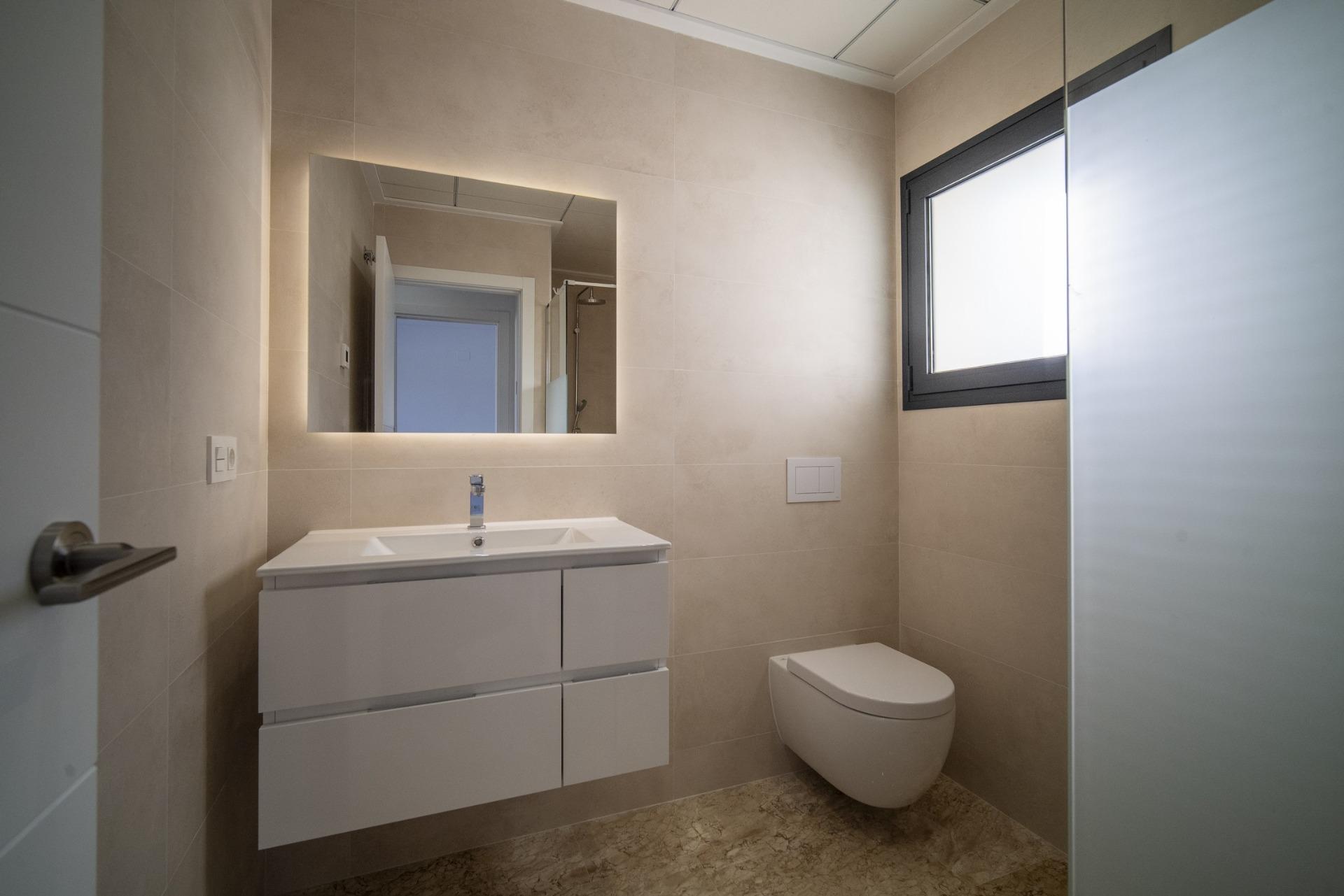 Bright modern bathroom with sleek fixtures and natural light in a 3-bedroom villa in La Nucia, Costa Blanca.