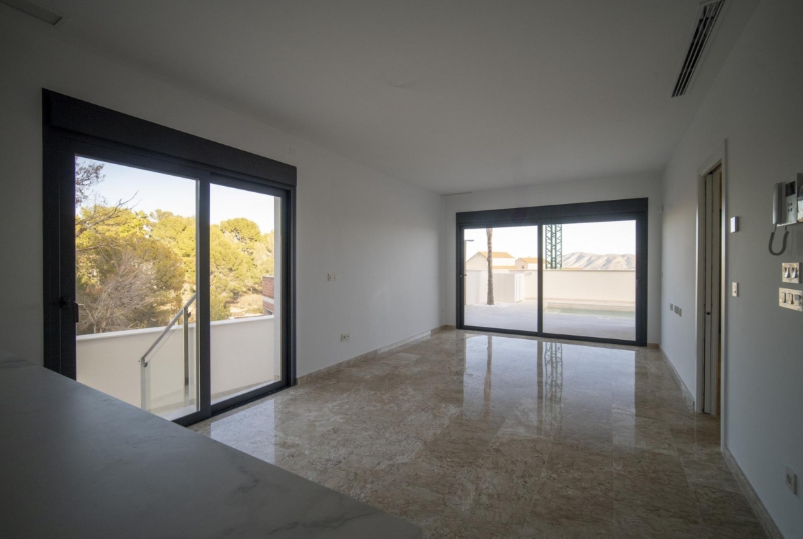 Bright modern living room with marble floors and large sliding windows in 3-bedroom villa, La Nucia, Costa Blanca.