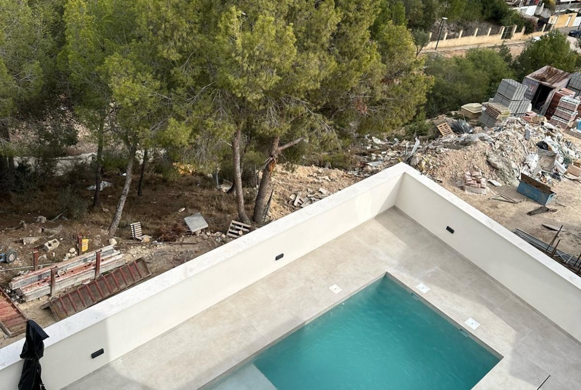 Modern new build 3 bedroom villa in La Nucia with a sleek, private rectangular pool and spacious sunlit terrace.